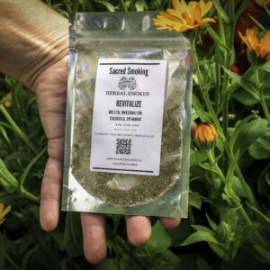 hand holding a pouch of loose herbs in a bush of calendula