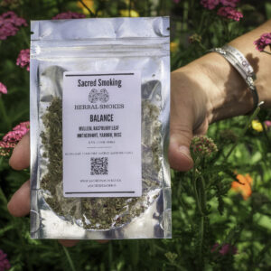 hand holding a pouch of loose herbs in a bush of yarrow